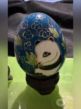 hand-painted glass egg from China, featuring a panda bear on a blue background